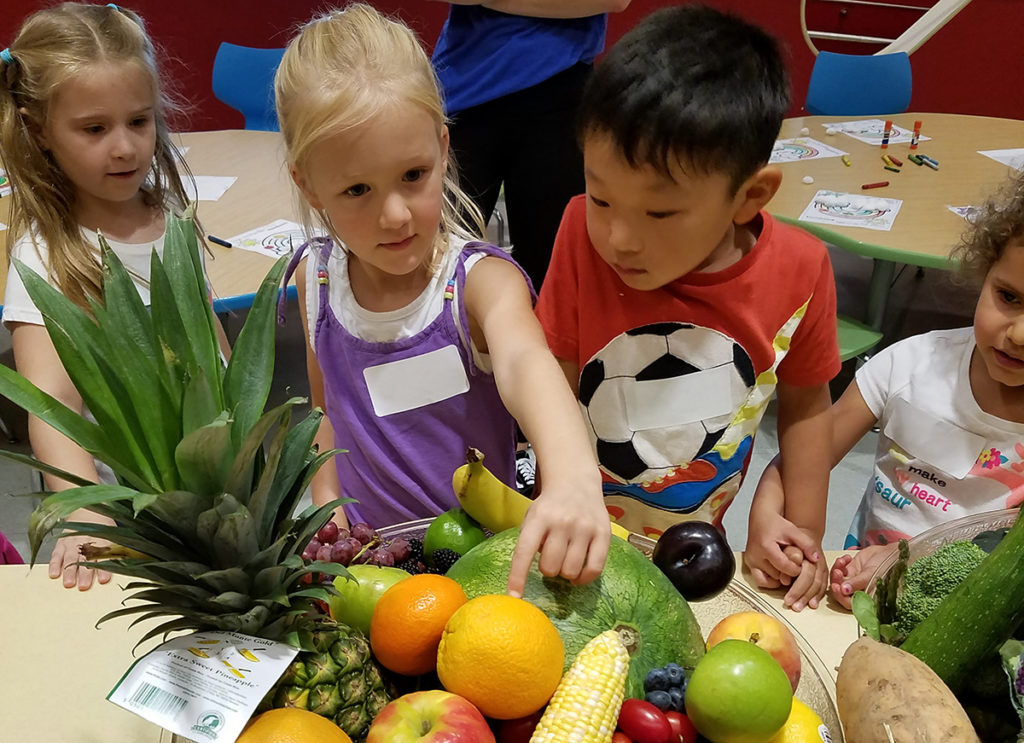 Children selecting fruit.