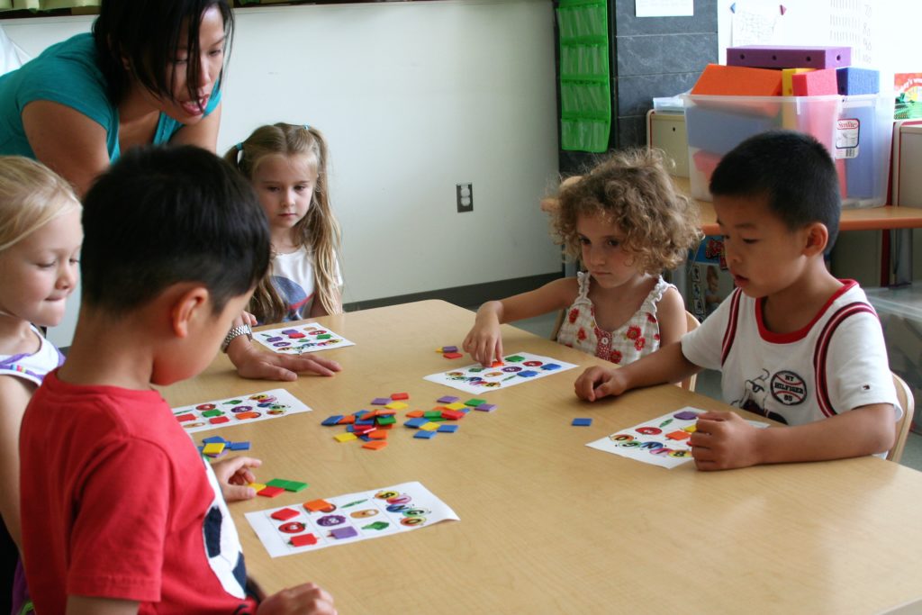 Children playing fruit and vegetable bingo.